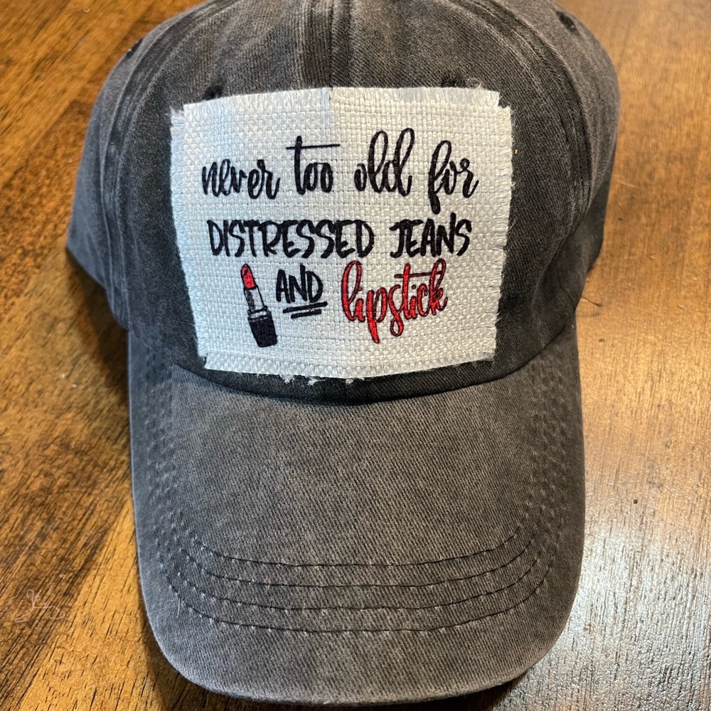 Never Too Old For Distressed Jeans and Lipstick Ponytail Cap